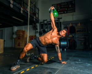 man in black shorts doing crossfit