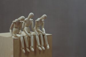 a group of wooden mannequins feeling fatigue